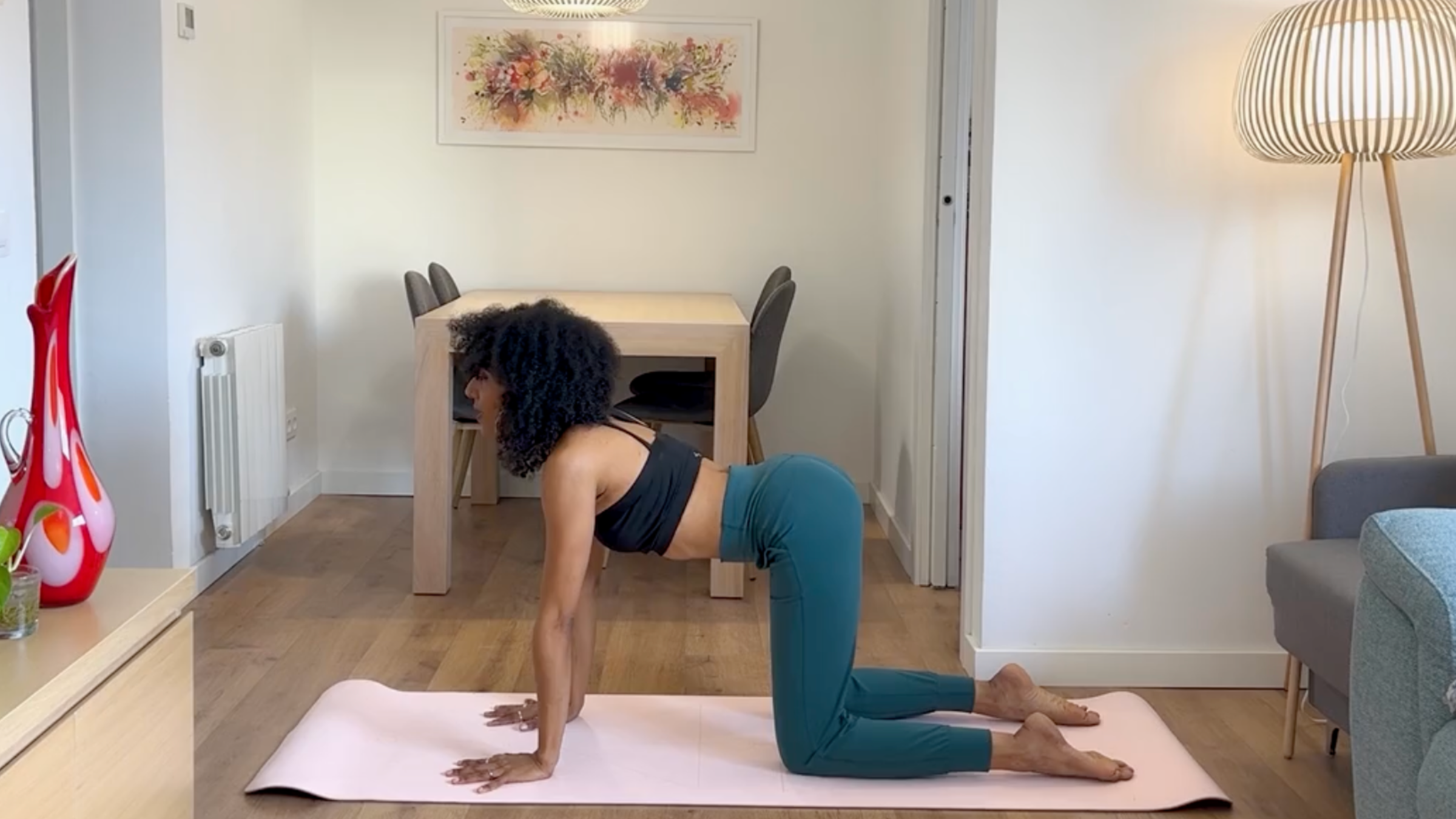 Yoga teacher practicing Cow Pose.